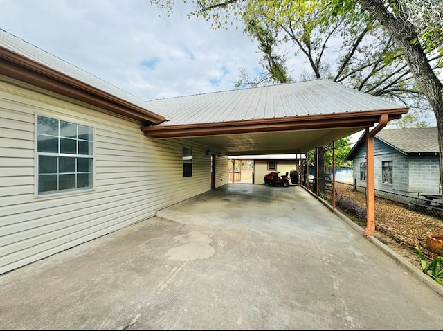 view of parking / parking lot featuring a carport