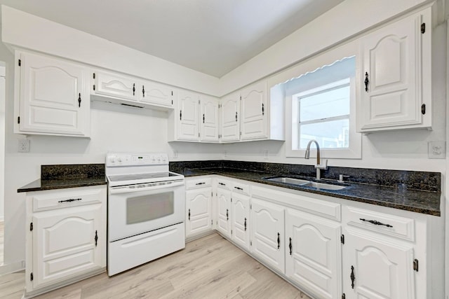 kitchen featuring dark stone counters, white electric range, sink, light hardwood / wood-style floors, and white cabinetry