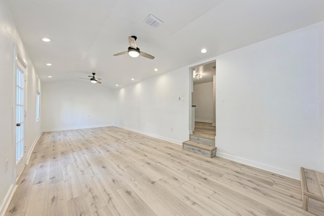 spare room with a wealth of natural light and light wood-type flooring