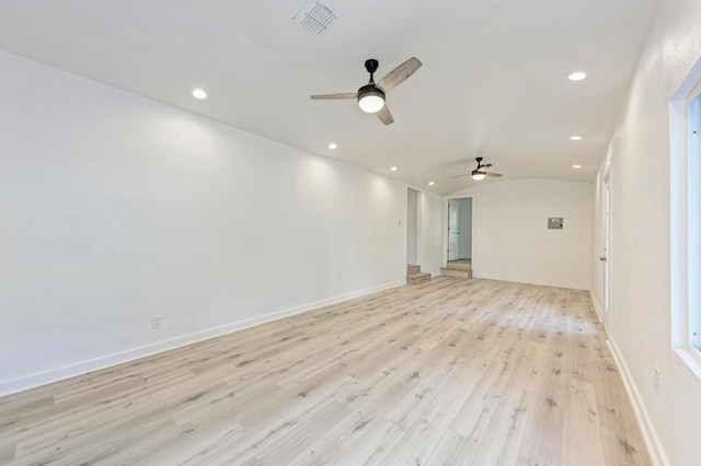 unfurnished room with ceiling fan, light hardwood / wood-style floors, and lofted ceiling