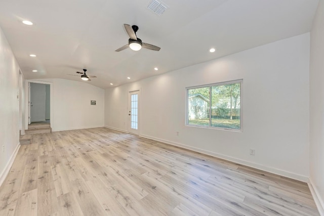 empty room with ceiling fan, light wood-type flooring, and vaulted ceiling