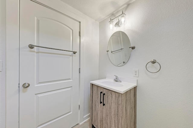 bathroom with vanity and a textured ceiling