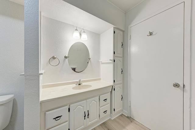 bathroom featuring hardwood / wood-style floors, vanity, and toilet