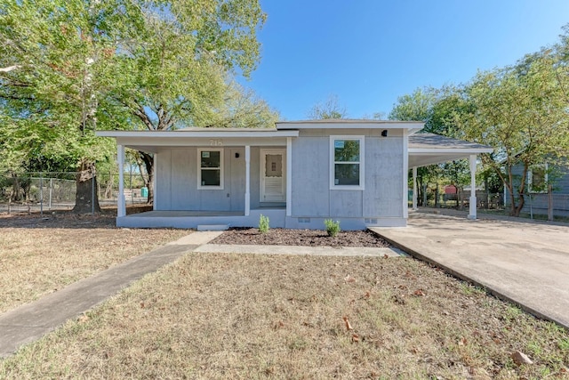 view of front of house with a carport, a porch, and a front lawn