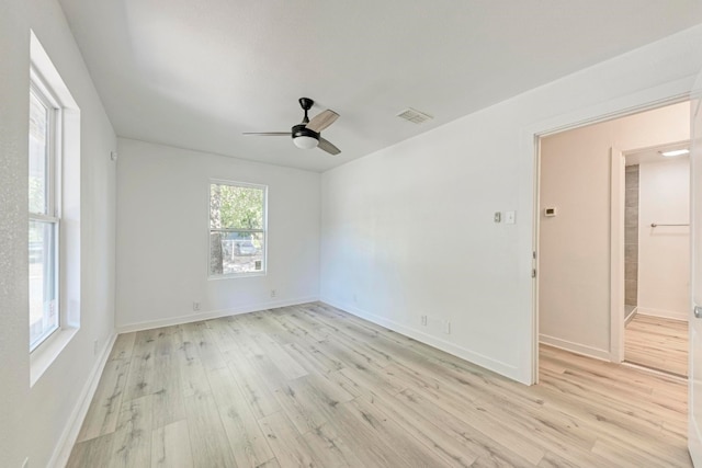 unfurnished room with ceiling fan and light wood-type flooring