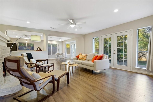 living room featuring french doors, ceiling fan, and wood-type flooring