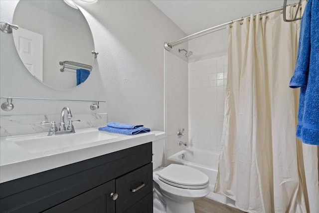 full bathroom with vanity, hardwood / wood-style flooring, shower / bath combo, and toilet