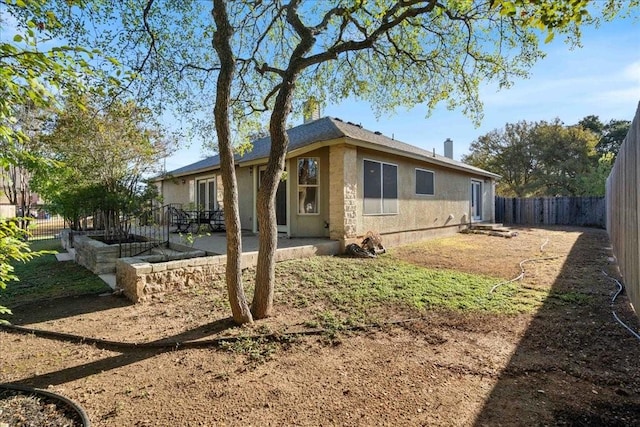 rear view of property featuring a patio