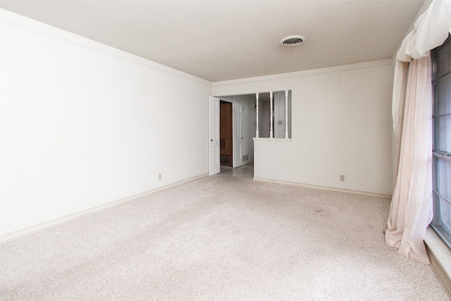 unfurnished room with crown molding