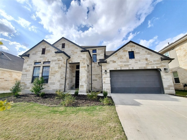 view of front of property featuring a garage and a front lawn