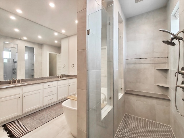 bathroom featuring tile patterned flooring, vanity, and plus walk in shower