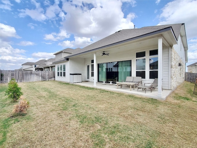 rear view of house featuring a patio, a lawn, and ceiling fan