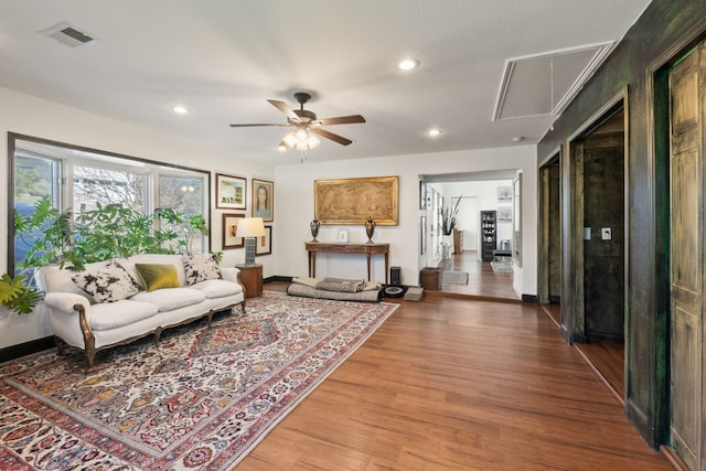 living room with ceiling fan and hardwood / wood-style floors