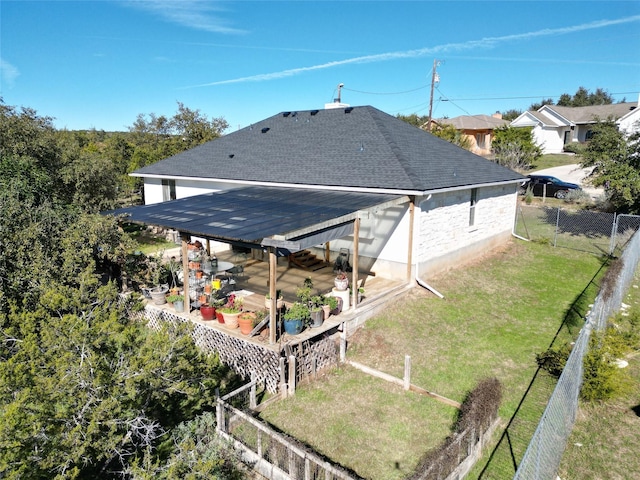 back of house featuring a lawn and a patio area