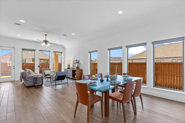 dining space featuring wood-type flooring and ceiling fan