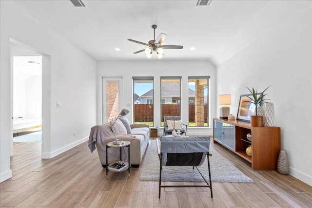 living room featuring light hardwood / wood-style flooring and ceiling fan