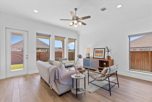 living room featuring ceiling fan and light hardwood / wood-style flooring