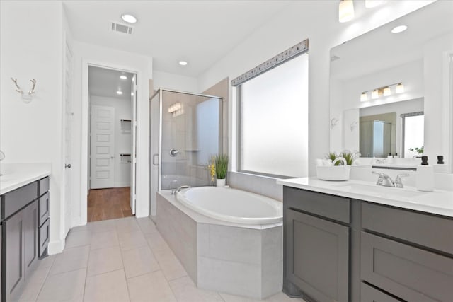 bathroom with plenty of natural light, vanity, tile patterned floors, and independent shower and bath