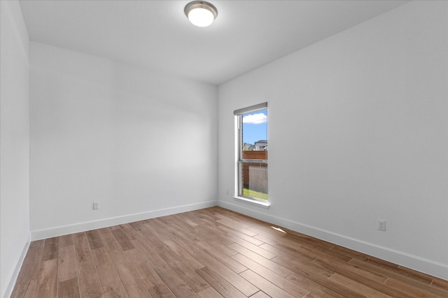 spare room with light hardwood / wood-style flooring