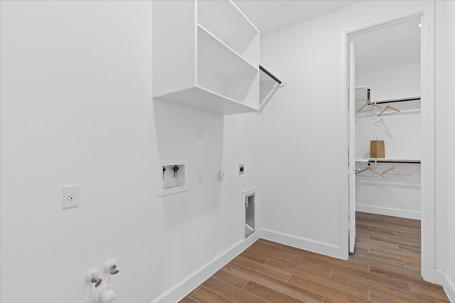 laundry area featuring hardwood / wood-style flooring, electric dryer hookup, gas dryer hookup, and washer hookup