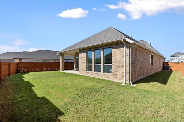 rear view of property featuring a lawn