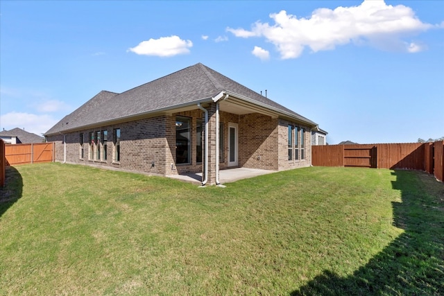 back of property featuring a patio and a yard