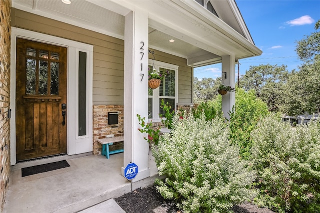 2717 Geraghty Ave, Austin, TX 78757 - doorway to property with covered porch and stone siding