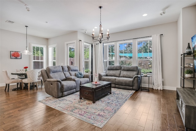 2717 Geraghty Ave, Austin, TX 78757 - living room featuring a chandelier, dark wood finished floors, recessed lighting, and baseboards