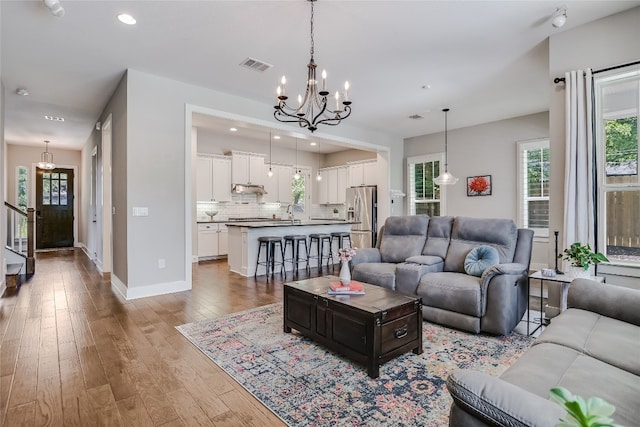 living room featuring hardwood / wood-style floors and a notable chandelier