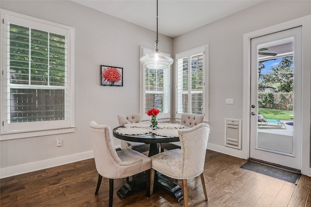 dining area featuring dark wood-type flooring and a chandelier