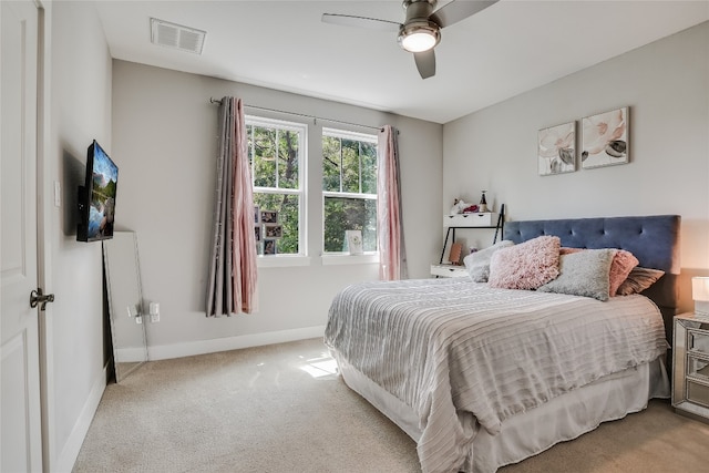 bedroom with ceiling fan and light colored carpet