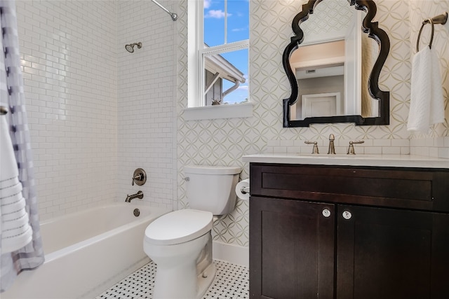 full bathroom featuring toilet, vanity, and tiled shower / bath