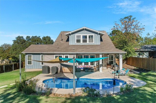 rear view of property featuring outdoor lounge area, a patio area, a lawn, and central AC