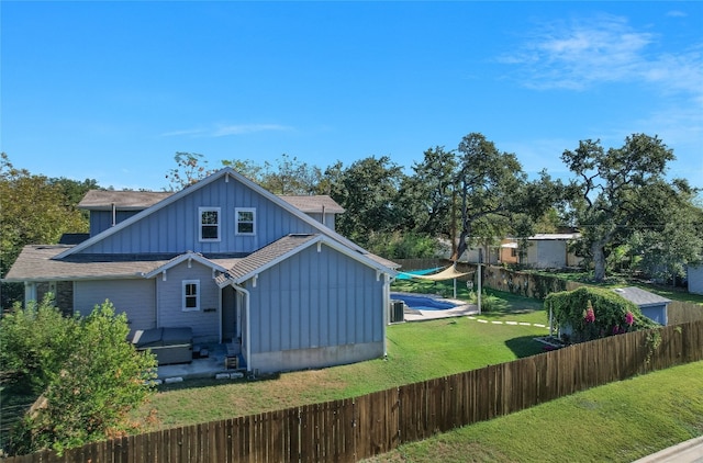 back of property featuring a yard