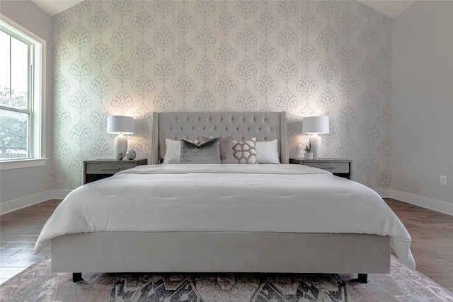 2717 Geraghty Ave, Austin, TX 78757 - bedroom featuring wood finished floors and wallpapered walls