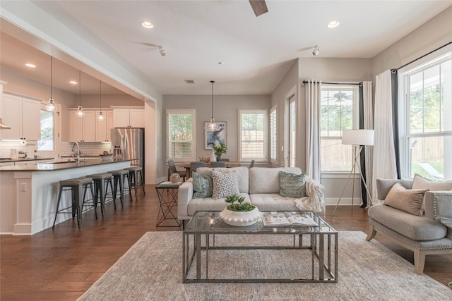 2717 Geraghty Ave, Austin, TX 78757 - living area featuring plenty of natural light, dark wood finished floors, and recessed lighting