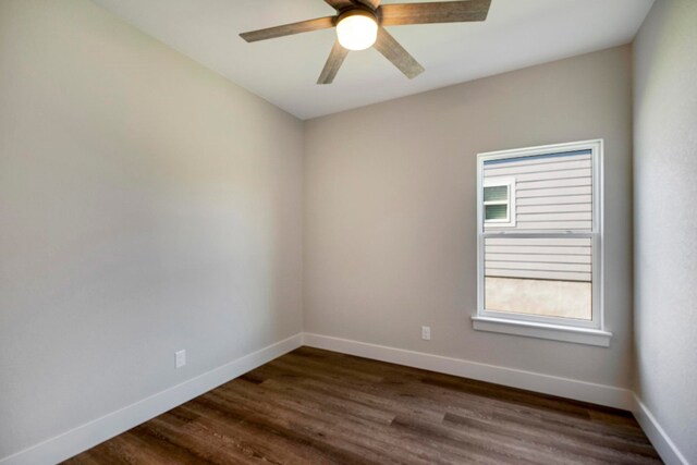 empty room featuring dark wood-type flooring and ceiling fan