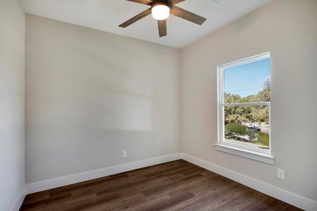 unfurnished room with dark hardwood / wood-style floors and ceiling fan