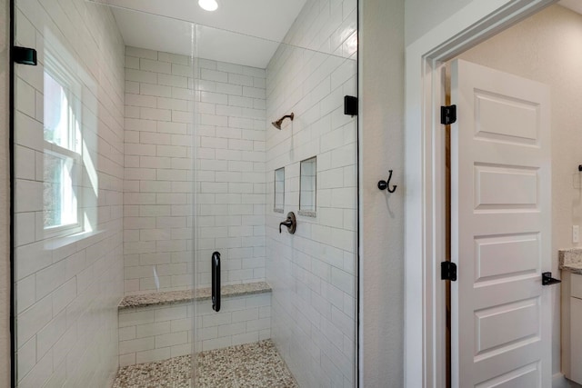 bathroom with walk in shower and vanity