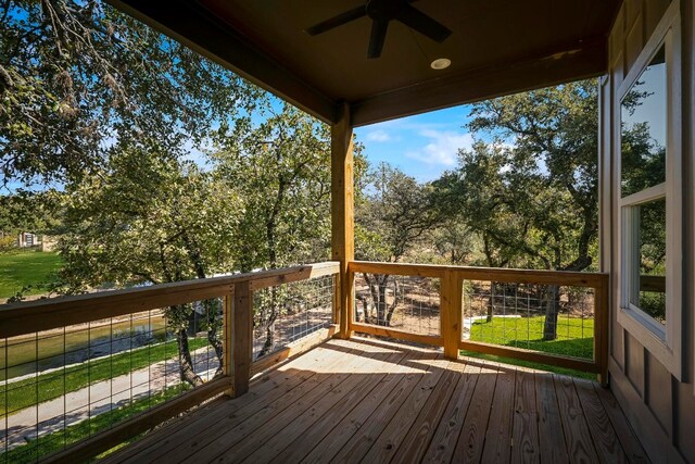 wooden deck featuring ceiling fan