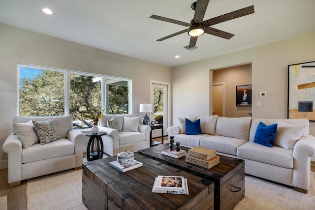 living room with light wood-type flooring and ceiling fan