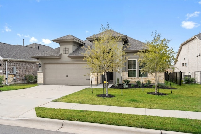 view of front of property featuring a front lawn and a garage