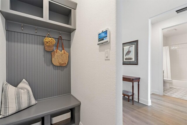 mudroom with light hardwood / wood-style floors