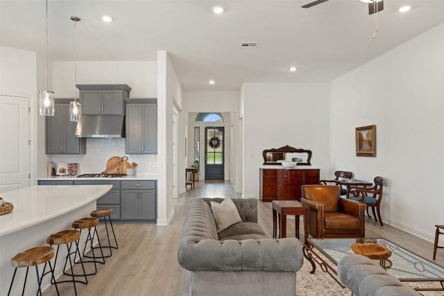 living room featuring light wood-type flooring and ceiling fan