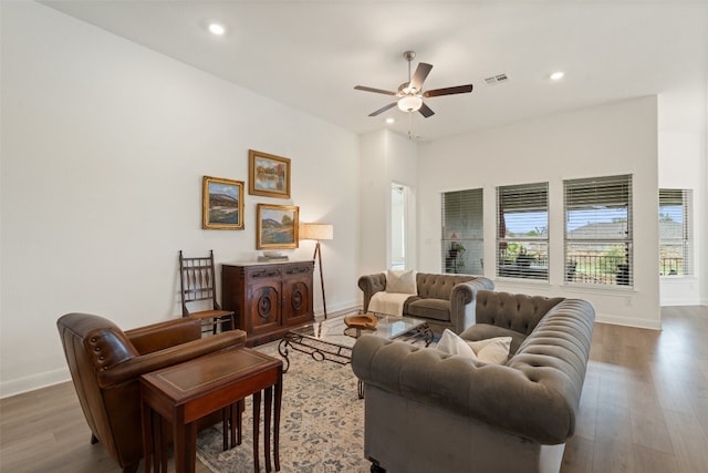 living room featuring hardwood / wood-style floors and ceiling fan