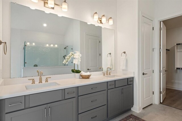 bathroom featuring a shower, hardwood / wood-style flooring, and vanity