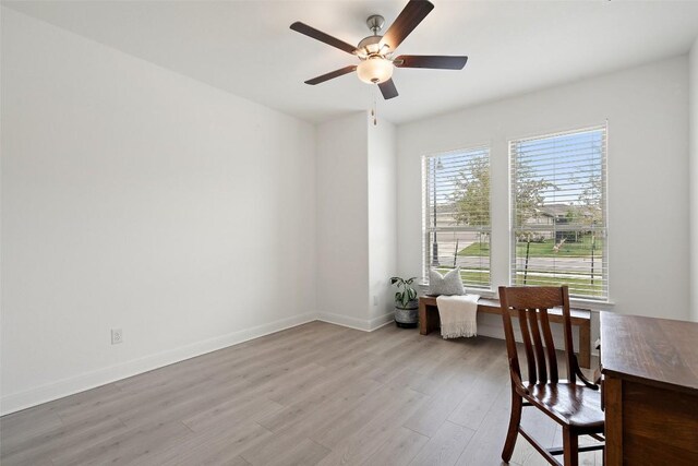 dining space featuring light wood-type flooring and ceiling fan