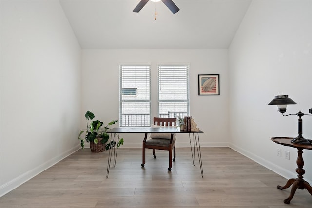 home office with light hardwood / wood-style floors, ceiling fan, and vaulted ceiling