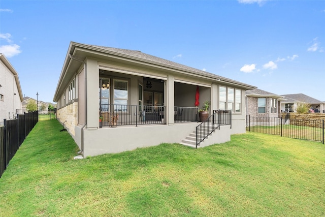 back of property featuring a lawn and a porch