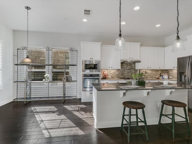 7405 Senger Pl, Austin, TX 78726 - kitchen with stainless steel appliances, dark wood finished floors, decorative backsplash, and recessed lighting